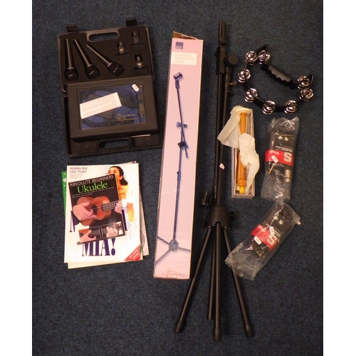 A tambourine, bagpipe chanter together with a group of microphones