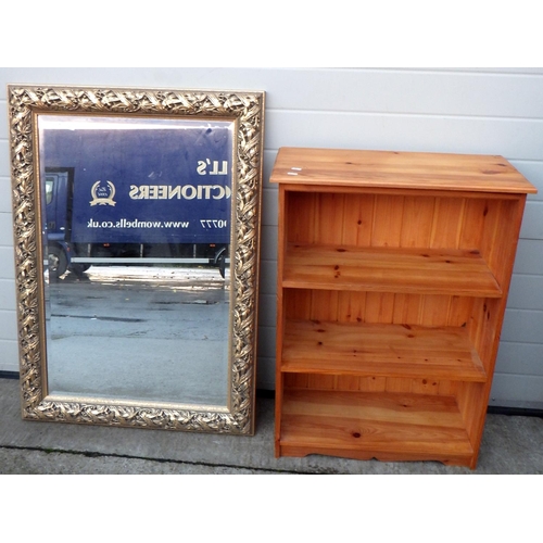 766 - A framed bevelled mirror together with a pine bookcase (2)