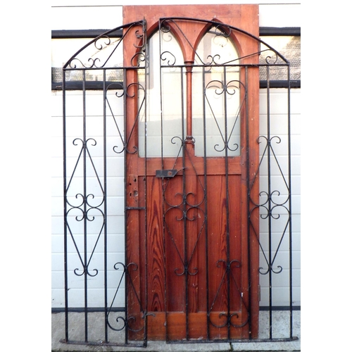 768 - A cast iron gate 124cm wide together with a pitch pine door