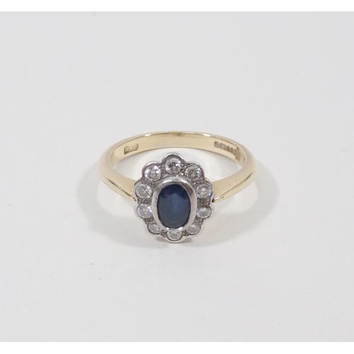 1 - A cluster ring, 18ct gold set with ten brilliant cut white stones around an oval cut blue stone.  Ce... 