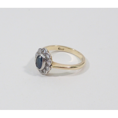 1 - A cluster ring, 18ct gold set with ten brilliant cut white stones around an oval cut blue stone.  Ce... 