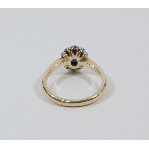 1 - A cluster ring, 18ct gold set with ten brilliant cut white stones around an oval cut blue stone.  Ce... 