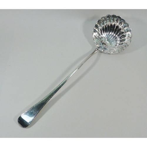 42 - A George III silver ladle having a shell-shaped bowl and a bright cut border to the handle, Richard ... 