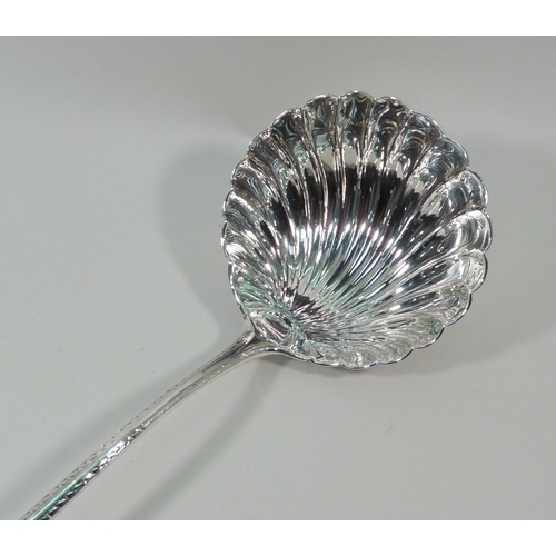 42 - A George III silver ladle having a shell-shaped bowl and a bright cut border to the handle, Richard ... 