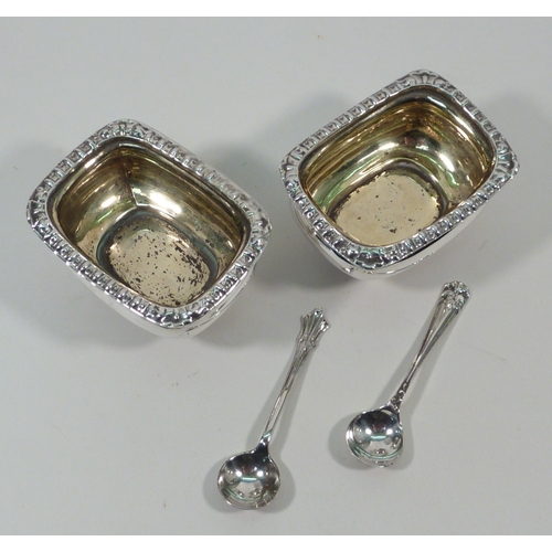 43 - A pair of silver salts, early 20th cent, together with two silver salt spoons.  Lacking glass liners... 