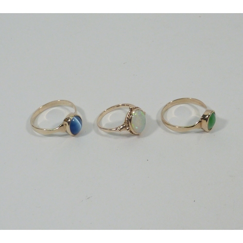 9 - An opal doublet ring, 9ct gold, head 12 x 11mm; two 9ct gold rings of similar design, both stone set... 