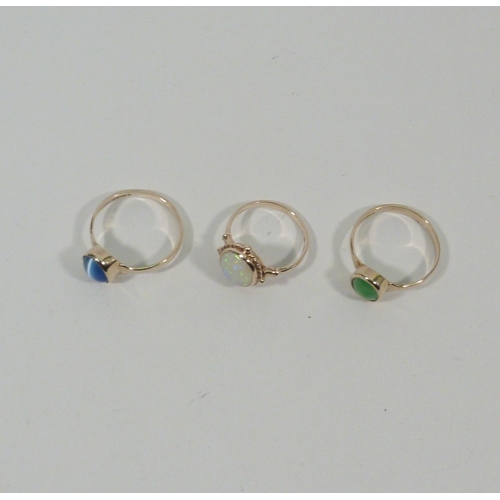 9 - An opal doublet ring, 9ct gold, head 12 x 11mm; two 9ct gold rings of similar design, both stone set... 