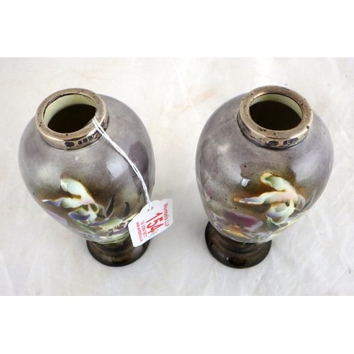 154 - A pair of silver mounted floral painted vases 15cm tall