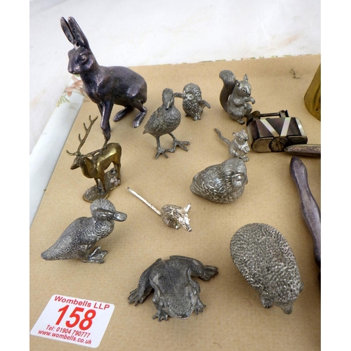 158 - A group of silver plated animals, nutcrackers, two brass bells etc