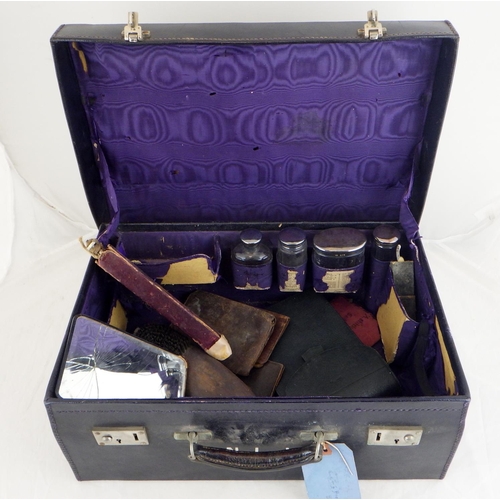 160 - A leather vanity case, insides af to include four silver topped bottles