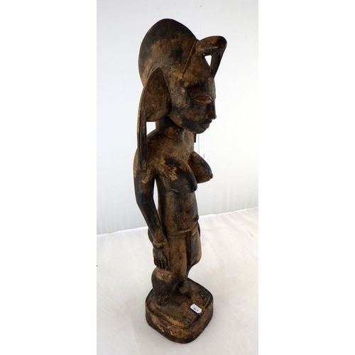 240 - A large carved tribal figure 58cm tall