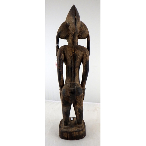 240 - A large carved tribal figure 58cm tall