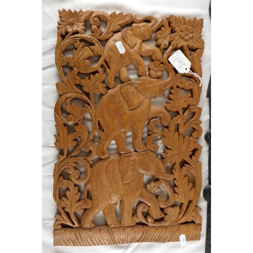 242 - A carved Balinese panel together with a carved elephant panel (2)