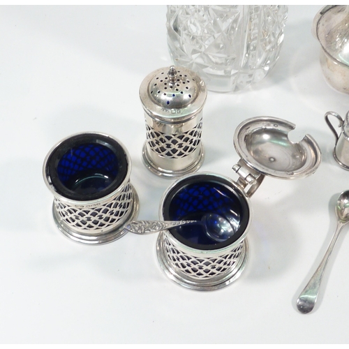 49 - A pair of silver pepper pots; a silver topped cut glass sugar sifter; other silver condiments.