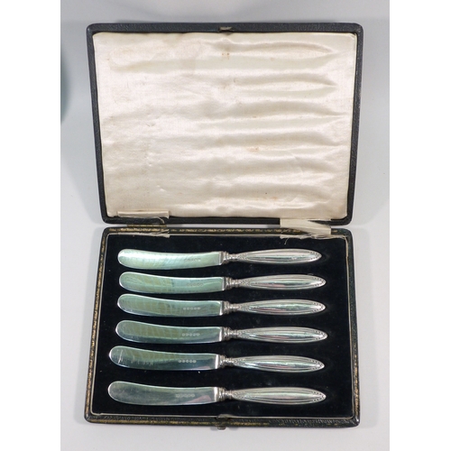 52 - A cased set of six silver bean terminal coffee spoons; two cased sets of six silver handled knives. ... 