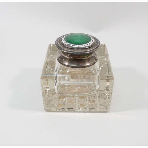 57 - A glass inkwell having a silver and enamel hinged lid, Henry Matthews, Birmingham, 1910.  75mm squar... 