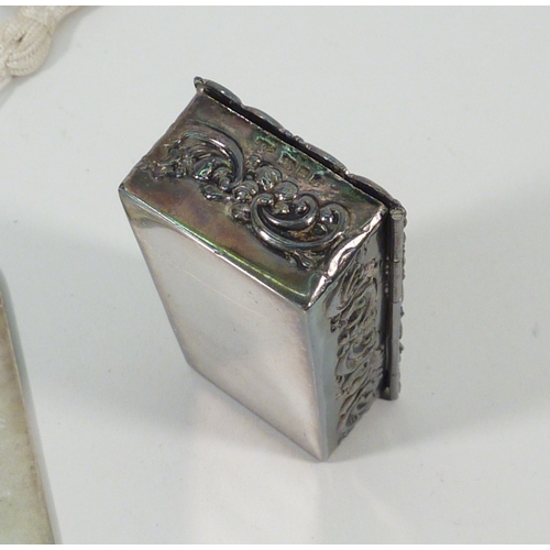 79 - A rectangular silver pill box, early 20th cent, 67 x 31mm; a Millennium commemorative silver bookmar... 