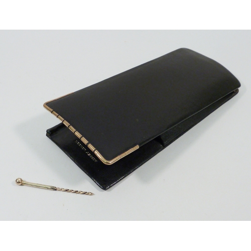 83 - An Asprey London cigar case with pricker, black leather having 9ct gold rim.  150 x 65mm.