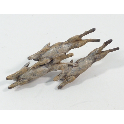 136 - A group of three cold painted bronze running rabbits, unsigned 65mm long; a cold painted bronze rat ... 