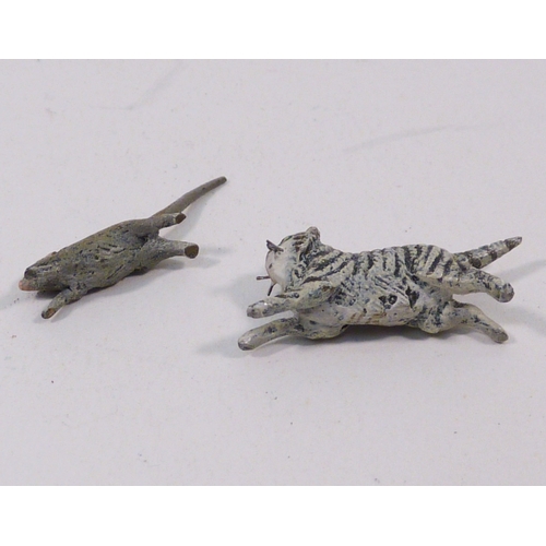 136 - A group of three cold painted bronze running rabbits, unsigned 65mm long; a cold painted bronze rat ... 