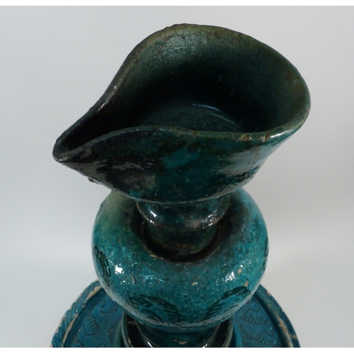 552 - A pottery oil burner lamp decorated with turquoise glaze, believed Persian, a/f.  Approx 350mm tall.