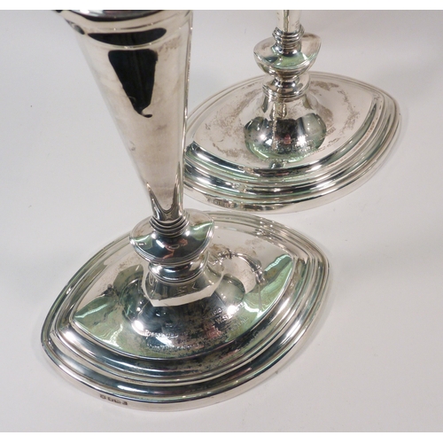 85 - A pair of silver candlesticks, early 20th cent in George III manner, presentation engraving to the b... 