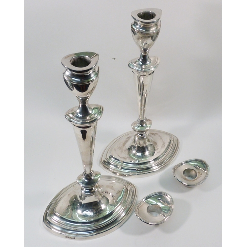 85 - A pair of silver candlesticks, early 20th cent in George III manner, presentation engraving to the b... 