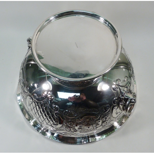 97 - A silver plated pedestal bowl, having two lion head ring handles and repousse decoration.  270mm dia... 