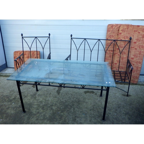 703 - A metal settee frame together with a matching armchair and a glass topped dining table and a similar... 