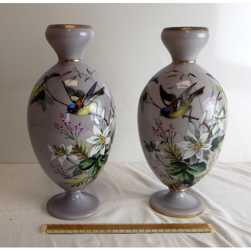 549 - A pair of Victorian opaque glass pedestal vases decorated in enamels with birds and foliage.  Each 3... 