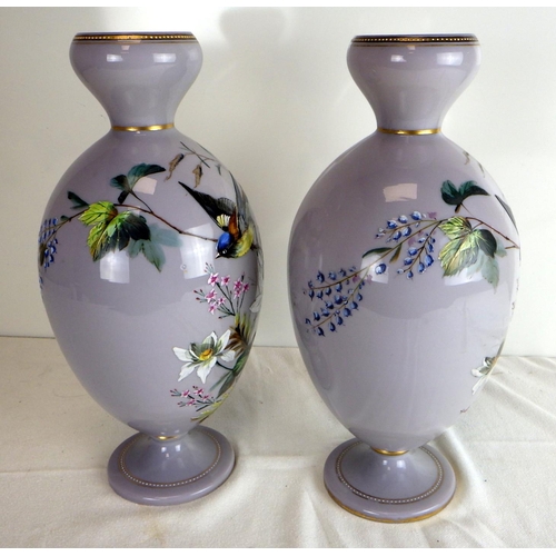 549 - A pair of Victorian opaque glass pedestal vases decorated in enamels with birds and foliage.  Each 3... 