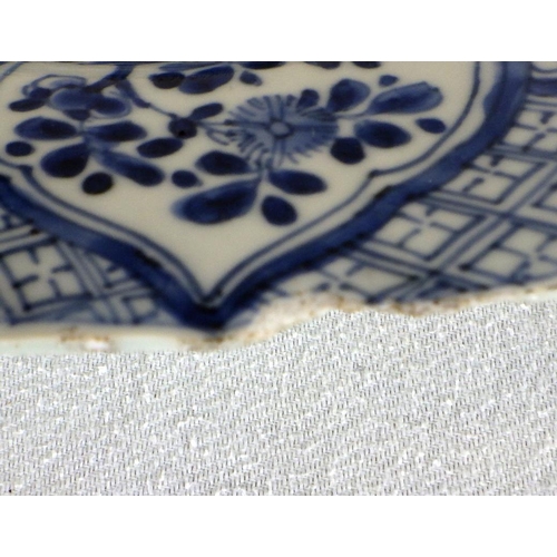 551 - A near pair of Chinese blue and white chargers, profusely decorated with floral panel scheme, the ba... 