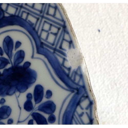 551 - A near pair of Chinese blue and white chargers, profusely decorated with floral panel scheme, the ba... 