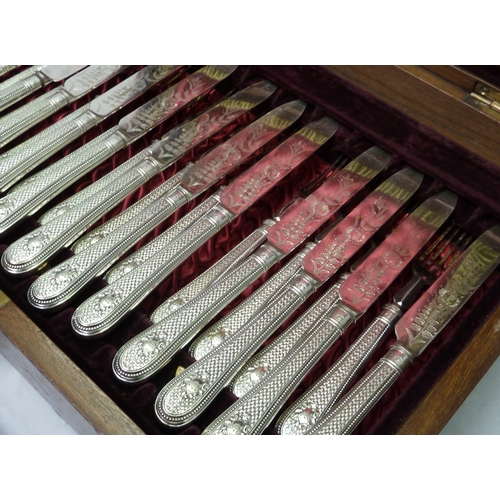 105 - An inlaid fitted case containing a set of six silver plated fish knives and forks and a set of twelv... 