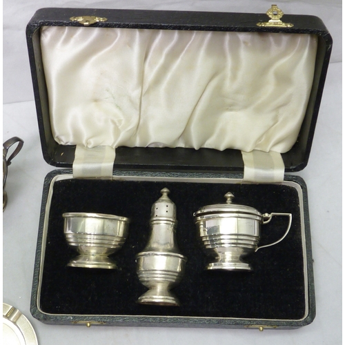 88 - A cased silver three piece condiment set, glass liners lacking; a silver boat-shaped pedestal salt, ... 