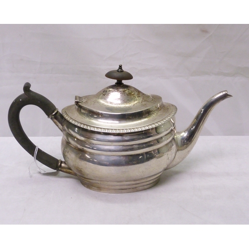 98 - A silver three piece tea set, early 20th cent.  Teapot 282mm long / 860gr gross