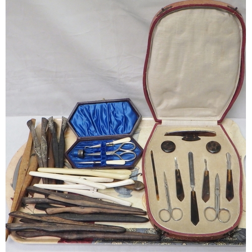 117 - A cased manicure set; a ladies travelling sewing set, incomplete; a collection of glove stretchers a... 