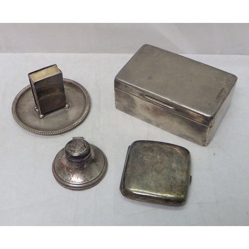 119 - A silver table-standing match box holder, London 1915; a silver cigarette case; a silver cigarette b... 