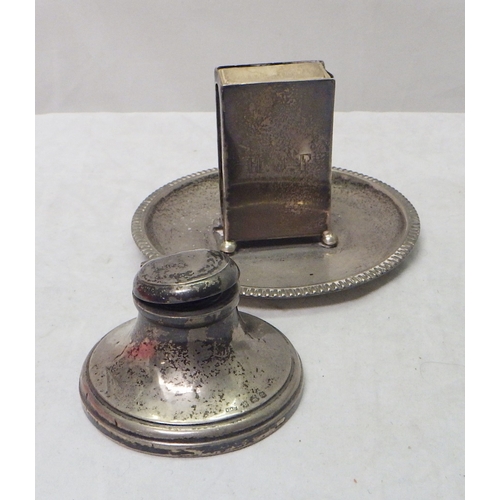 119 - A silver table-standing match box holder, London 1915; a silver cigarette case; a silver cigarette b... 