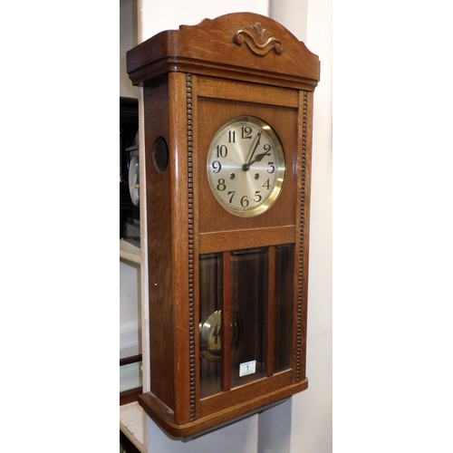 1 - An oak cased striking wall clock 80cm long