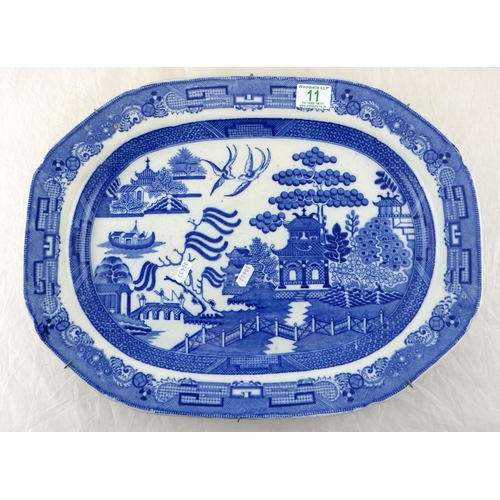 11 - A large 19th C blue and white Willow pattern plate 49 x 37cm