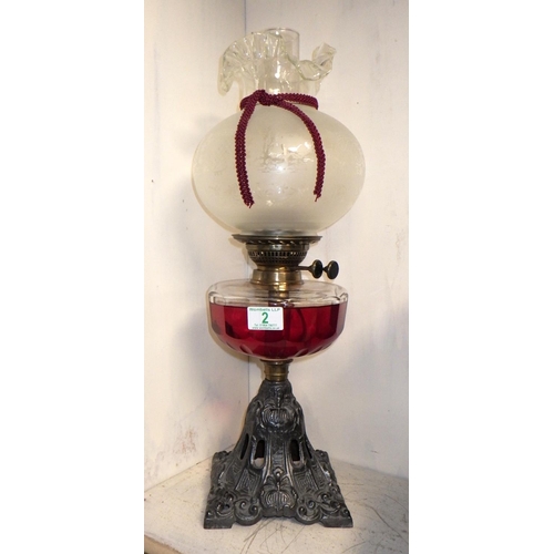 2 - A cast metal based oil lamp 55cm tall (clear glass well)