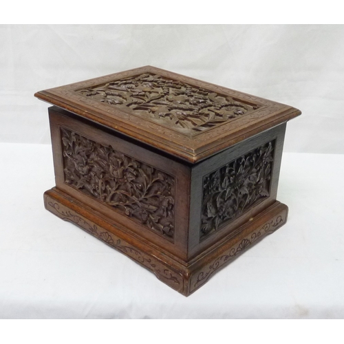 34 - An Oriental motif tea caddy, carved hardwood with a pewter liner.