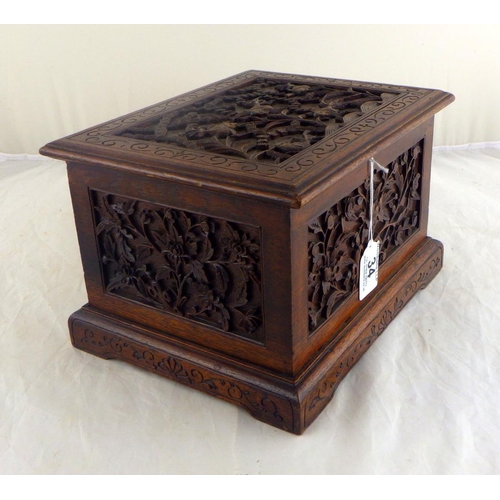 34 - An Oriental motif tea caddy, carved hardwood with a pewter liner.