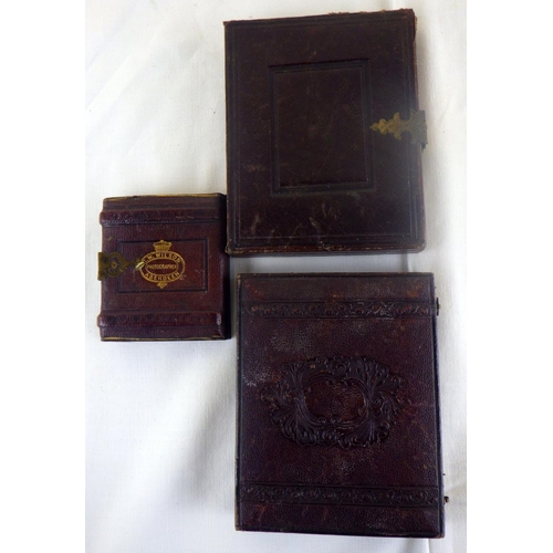 299 - Two Victorian Ambrotype portrait photographs mounted in leather cases with tooled velvet lining;  a ... 