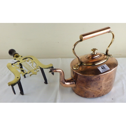 48 - A Victorian copper kettle on brass hearth trivet with wooden handle (2).