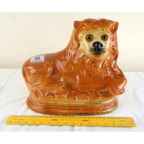 49 - A 19th century Staffordshire lion 25cm high and 30cm long.