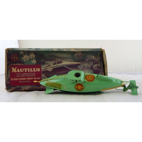 105 - A boxed Nautilus submarine together with a clockwork tin plate train (2)