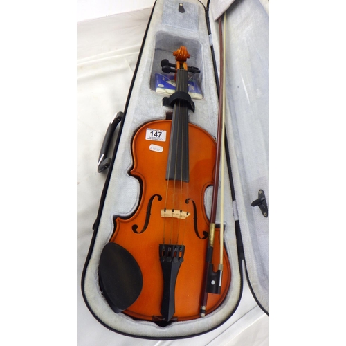 147 - A modern violin and bow, cased.