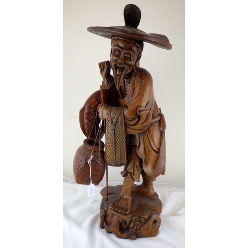 292 - An Oriental large hardwood carved figure of a fisherman 70cm tall